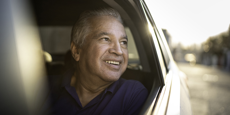 Guy looking out the car smiling