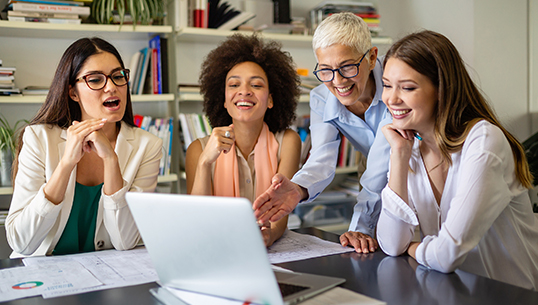 Group of ladies smiling looking at the computer